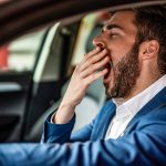image-tired-mid-adult-businessman-driving-a-car-and-yawning