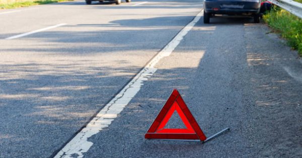 image-red-emergency-stop-sign-red-triangle-warning-sign-and-broken-car-on-a-road